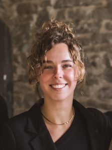 Smiling woman in professional attire at Workforce Nutrition Alliance contact page.